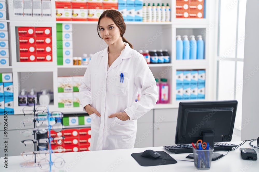 Young woman pharmacist smiling confident standing at pharmacy Young woman pharmacist smiling confident standing at pharmacy