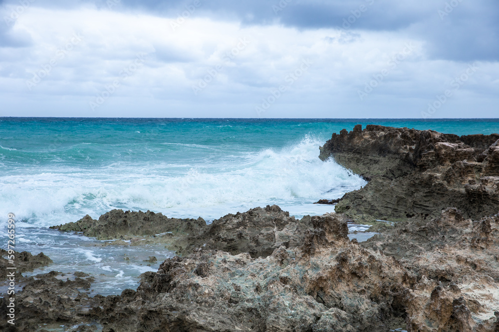 Tropical storm in the Atlantic Ocean. Beautiful rocky shore with rolling waves. Hurricane in Caribbean Sea, Gulf of Mexico, Cancun.