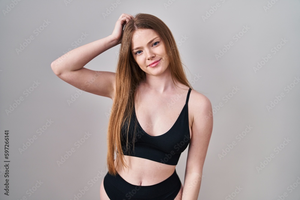 Young caucasian woman wearing lingerie confuse and wonder about question. uncertain with doubt, thinking with hand on head. pensive concept. Young caucasian woman wearing lingerie confuse and wonder about question. uncertain with doubt, thinking with hand on head. pensive concept.