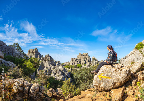 Woman on mountain peak. Landscape with sport woman in Torcal de Antequera in Spain. Travel and tourism. Hiking