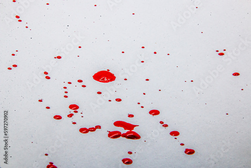 Red drops of paint on a white background 