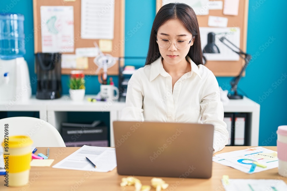 Young chinese woman business worker using laptop working at office Young chinese woman business worker using laptop working at office