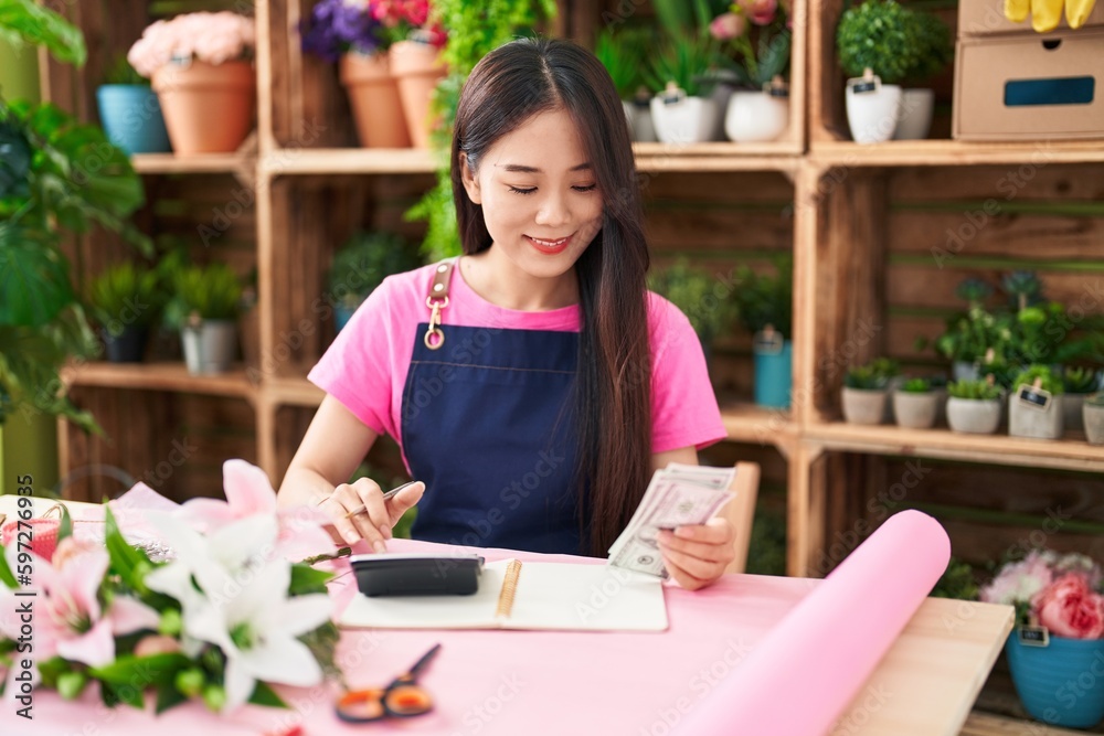 Young chinese woman florist smiling confident counting dollars at flower shop Young chinese woman florist smiling confident counting dollars at flower shop