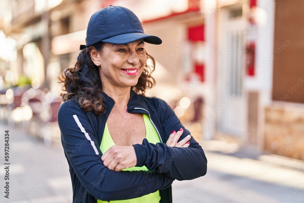 Fototapeta premium Middle age hispanic woman working out outdoors