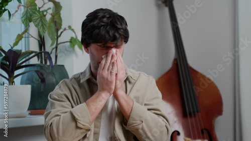 The man caught a cold, he has the flu, a runny nose. Healthcare and medical concept