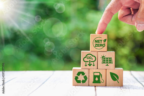 Reduction of carbon emissions, carbon neutral concept. Net zero greenhouse gas emissions target. Reducing carbon footprint concept. Decreasing CO2 emissions target symbol on wooden cube, natural green