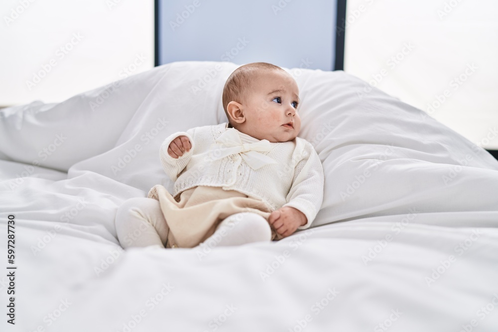 Adorable baby relaxed lying on bed at bedroom Adorable baby relaxed lying on bed at bedroom