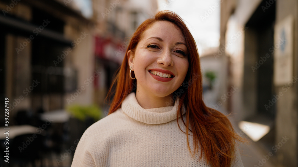Young redhead woman smiling confident walking at street