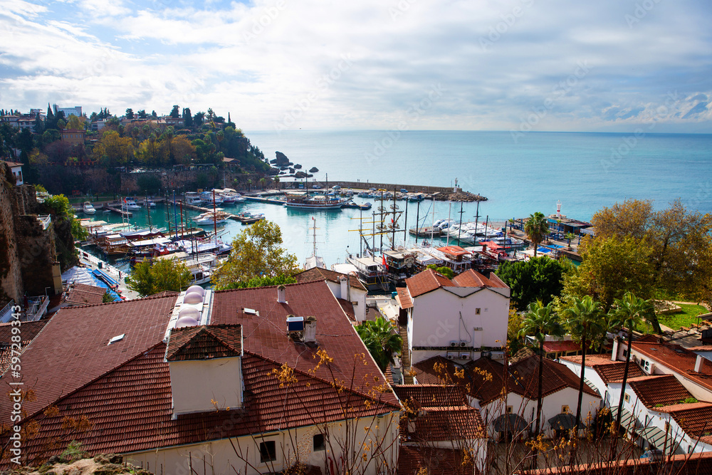 The old port of Antalya - Antalya Kaleici Yat Limani. The old town. With yachts, boats. and old buildings. View from above. Antalya, Turkiye.