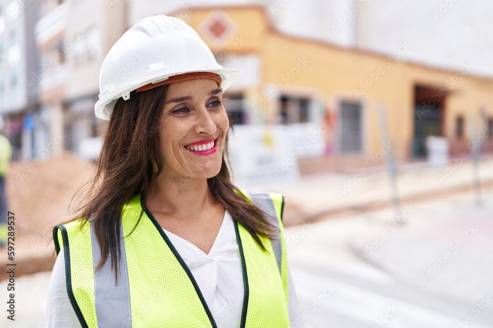 Young beautiful hispanic woman architect smiling confident standing at street Young beautiful hispanic woman architect smiling confident standing at street