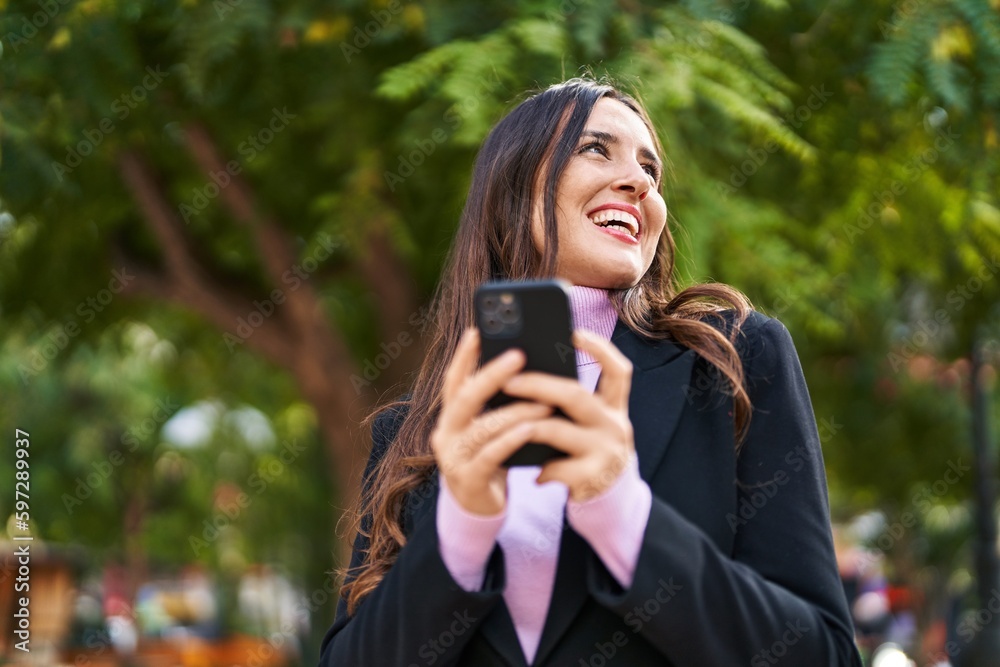 Young hispanic woman smiling confident using smartphone at park Young hispanic woman smiling confident using smartphone at park