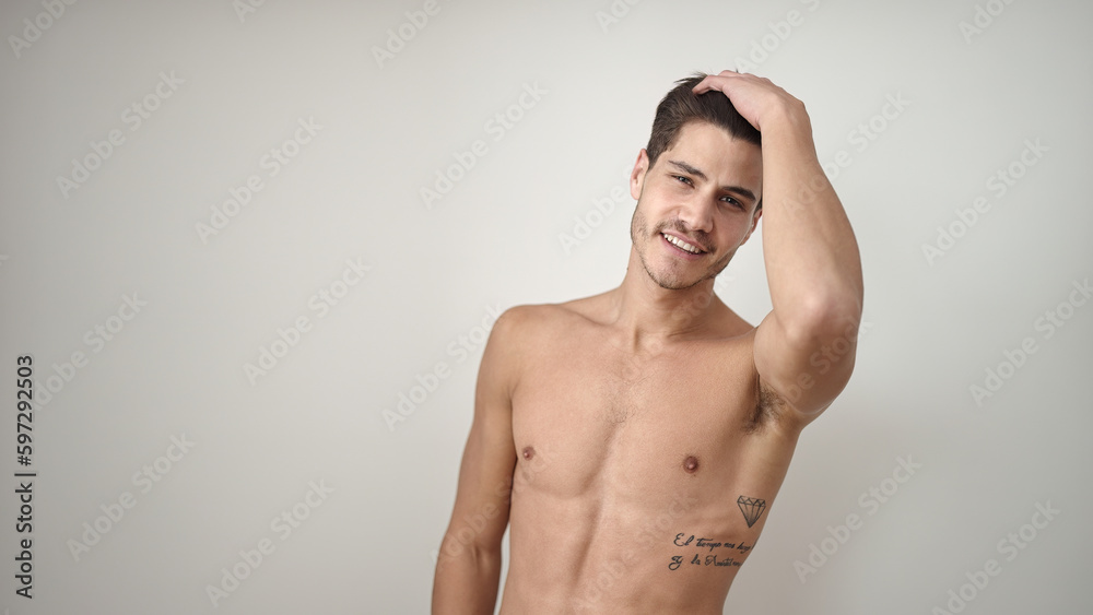Young hispanic man smiling confident combing hair with hand over isolated white background