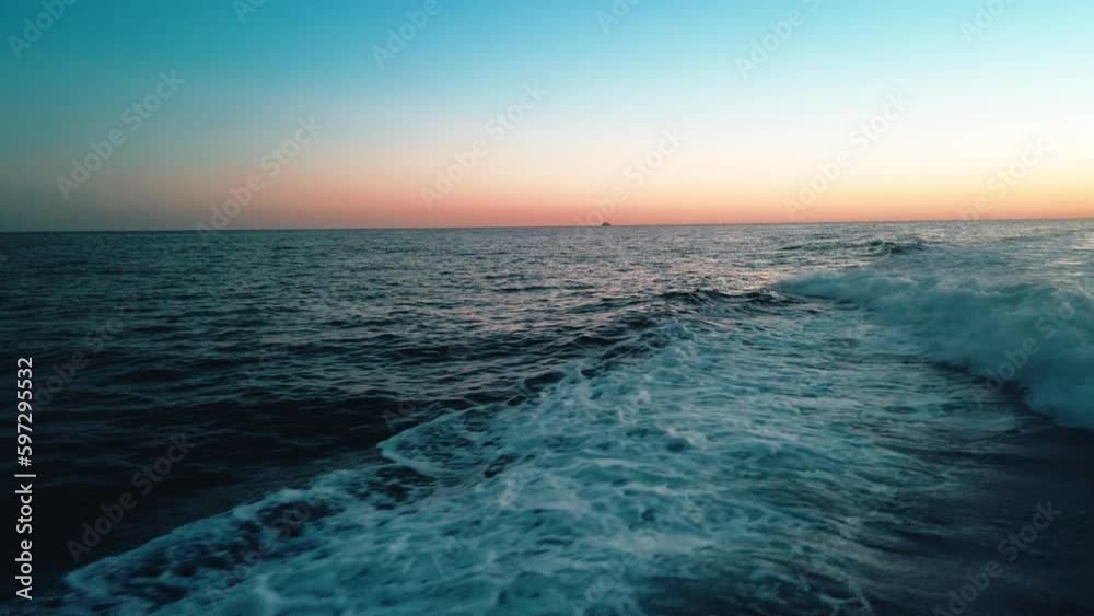 motorboat wake at sunset light 