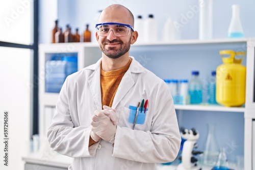 Young man scientist standing at laboratory
