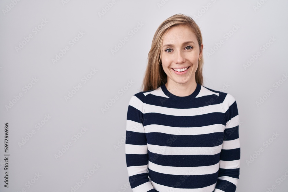 Young caucasian woman wearing casual navy sweater with a happy and cool smile on face. lucky person. Young caucasian woman wearing casual navy sweater with a happy and cool smile on face. lucky person.