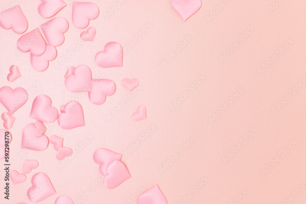 Textile hearts confetti on a pink glittering background. Place for your design. Monochrome concept.