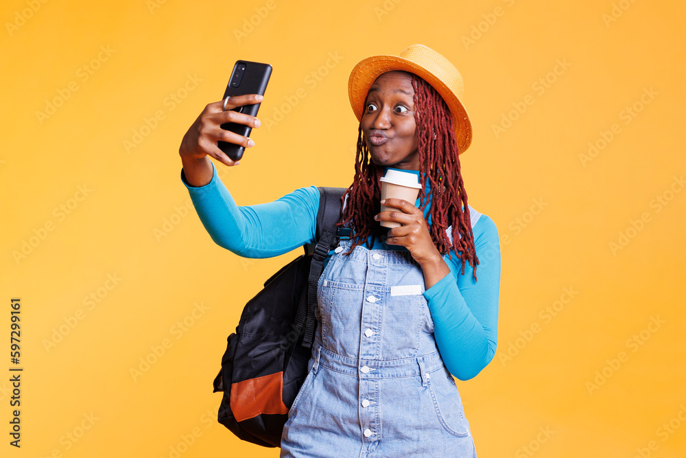 Joyful woman taking photos on vacation holiday, feeling excited with coffee on international journey in studio. Young person having fun with pictures, urban adventure with images. Joyful woman taking photos on vacation holiday, feeling excited with coffee on international journey in studio. Young person having fun with pictures, urban adventure with images.