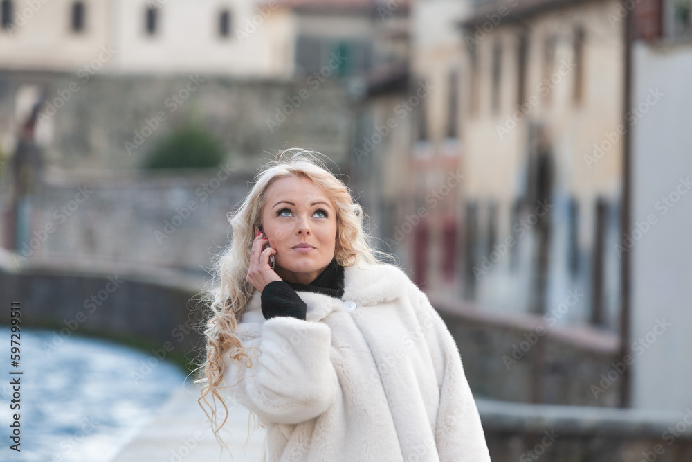 woman in Medieval European city, using phone woman in Medieval European city, using phone