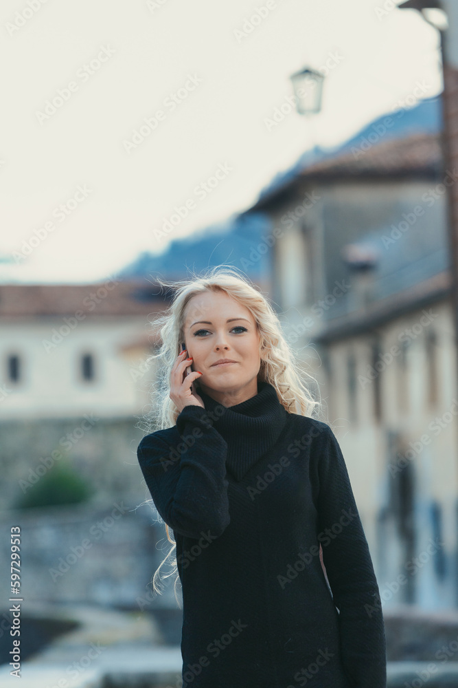 Fototapeta premium Curly blonde tourist at phone, perfect makeup