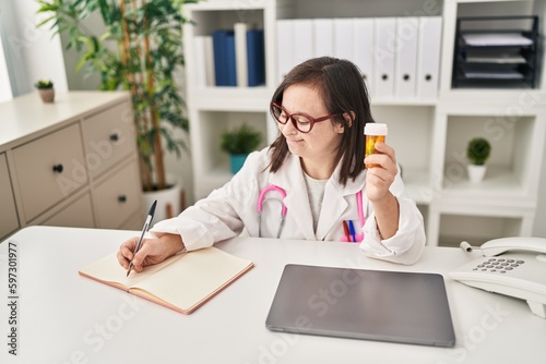 Down syndrome woman wearing doctor uniform prescribe pills treatment at clinic