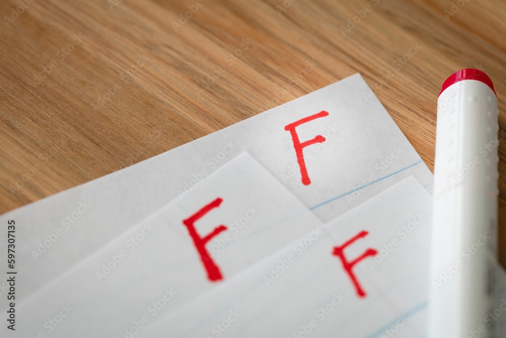 Bad grade F is written with red pen on the tests.  - obrazy, fototapety, plakaty 
