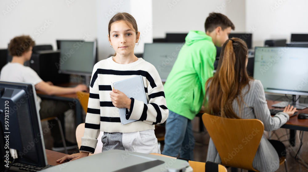 Portrait of schoolgirl girl in a computer class at school