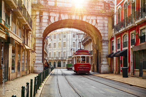 Obraz na płótnie Lisbon, Portugal. Vintage red retro tram on narrow bystreet tramline in Alfama district of old town. Popular touristic attraction Lisboa city. Public tramways trasport w salonie