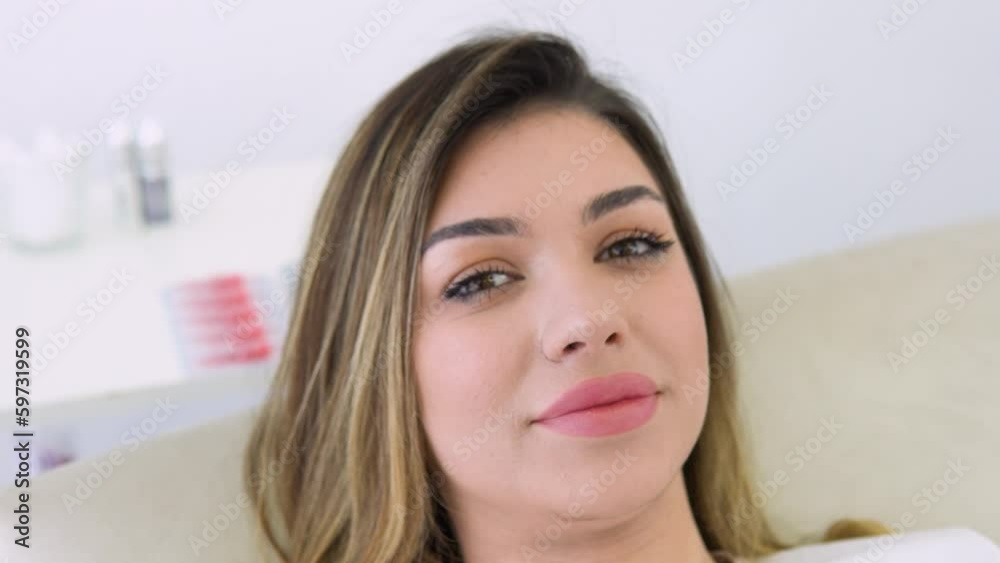 Beautiful young woman lies in a beauty parlor after the procedure permanent make up of lips Beautiful young woman lies in a beauty parlor after the procedure permanent make up of lips