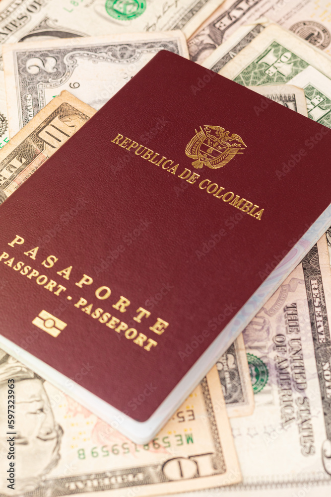 A Colombian passport on American bills of different denominations. International ID on dollars. A Colombian passport on American bills of different denominations. International ID on dollars.