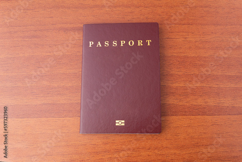 A new passport isolated on a wooden desk