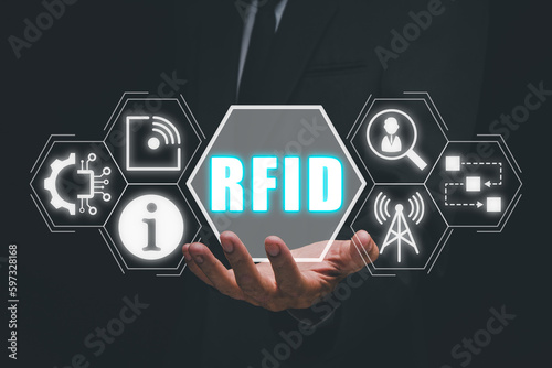 RFID, Radio frequency identification concept, Businessman hand holding Radio frequency identification icon on virtual screen.