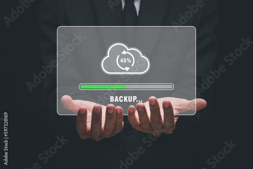 Backup storage data internet technology business concept, Businessman hand holding backup icon on virtual screen.