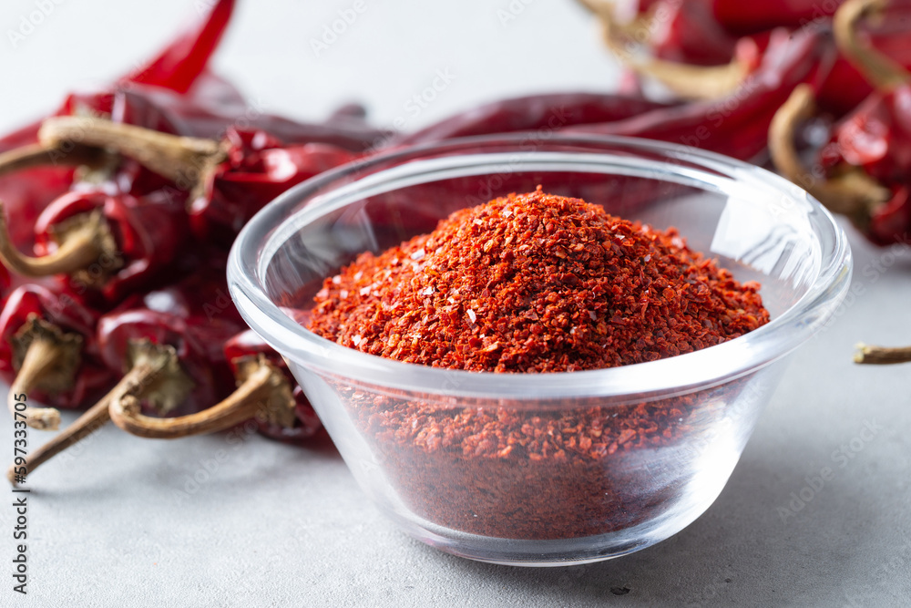 Dried red chillies and chili powder on a cutting board Dried red chillies and chili powder on a cutting board