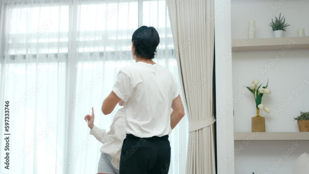 Happy young couple dancing and laughing having fun celebrate at house in living room Happy young couple dancing and laughing having fun celebrate at house in living room