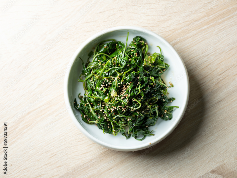 Seasoned greens on a plate, side dish Seasoned greens on a plate, side dish