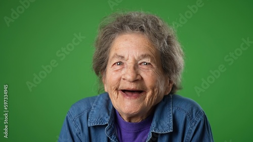 Cuadro en lienzo Closeup portrait of toothless elderly senior old woman with wrinkled skin and grey hair getting great happy with success winner isolated on green screen background