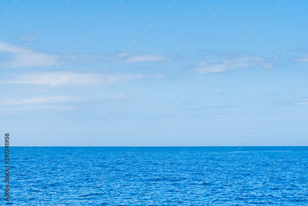 Blue sea and white clouds on sky. Water cloud horizon background. Feeling calm, cool, relaxing. The idea for cold background and copy space on the top. the ocean deep indigo Blue sea and white clouds on sky. Water cloud horizon background. Feeling calm, cool, relaxing. The idea for cold background and copy space on the top. the ocean deep indigo