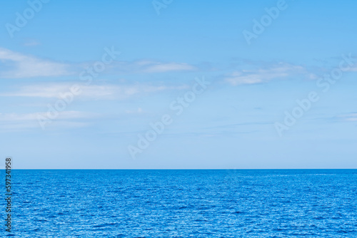 Blue sea and white clouds on sky. Water cloud horizon background. Feeling calm  cool  relaxing. The idea for cold background and copy space on the top. the ocean deep indigo