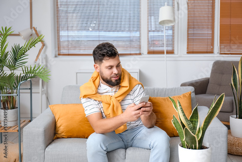 Young bearded man using mob...