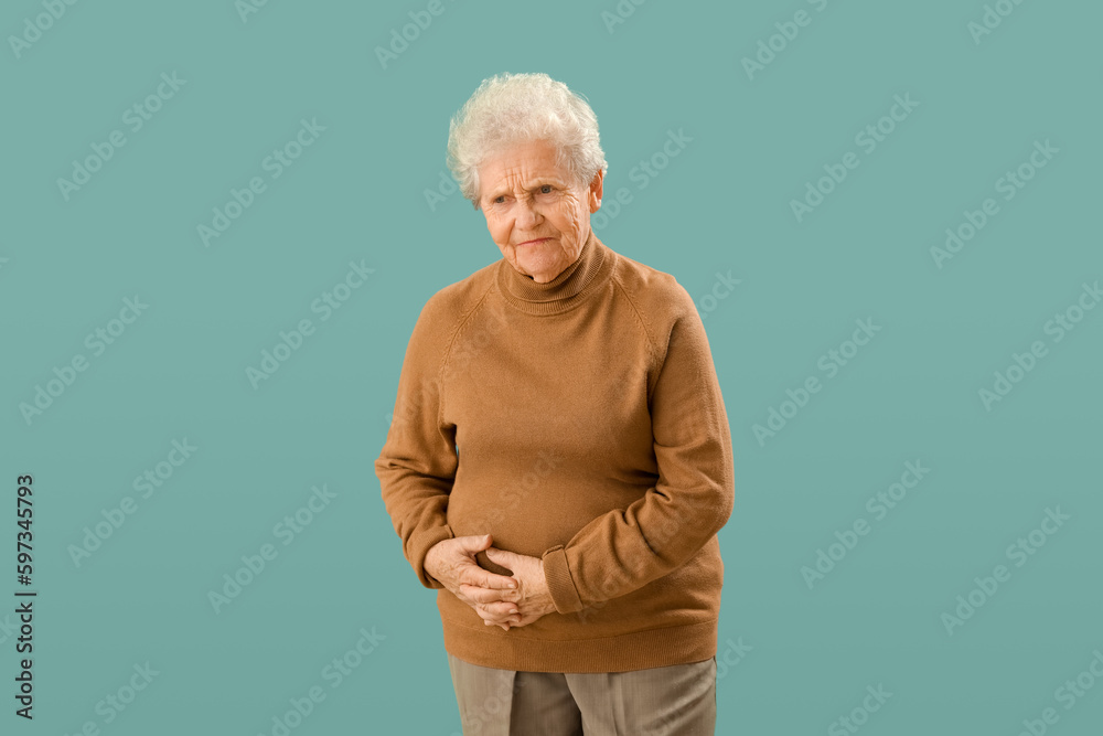 Senior woman with appendicitis on green background Senior woman with appendicitis on green background