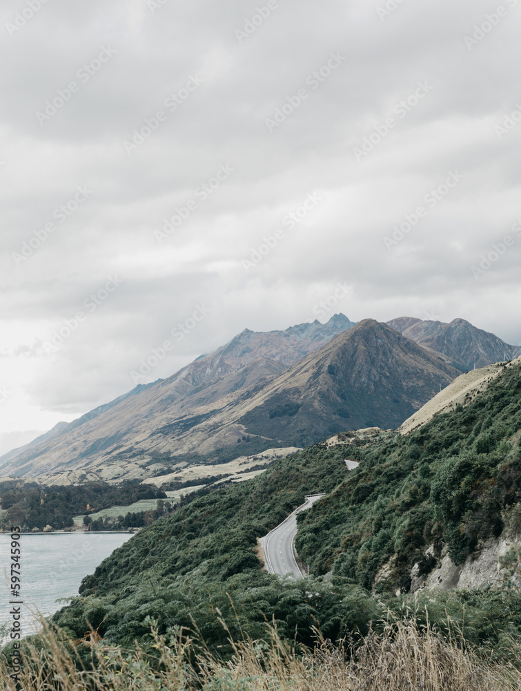  Landscape of a mountain lake, roads, mountains. Road along Lake Wakatipu, Queenstown, New Zealand. 