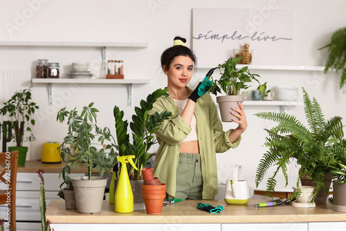 Young woman with green hous...