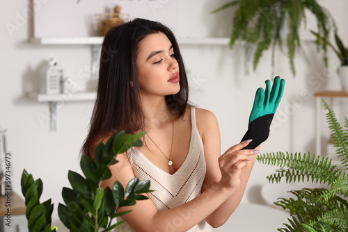 Young woman with houseplant...