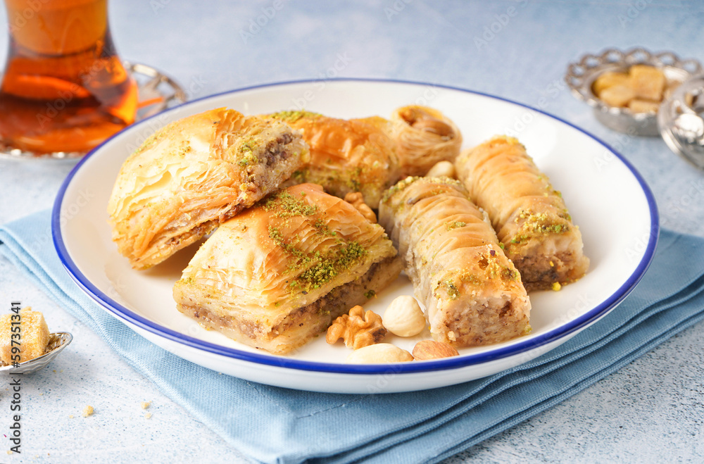 Plate with tasty baklava on light background, closeup Plate with tasty baklava on light background, closeup
