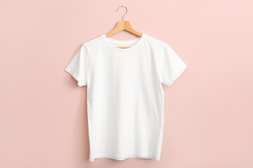 White t-shirt hanging on pink wall
