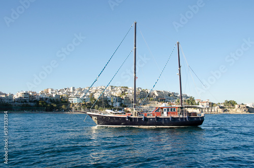 Traditional wooden sail cruise boat floating to Piraeus port, Greece