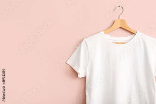 White t-shirt hanging on pink wall