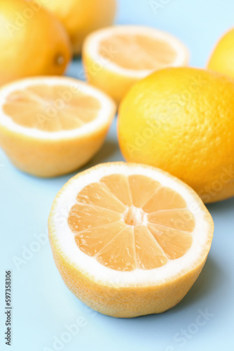 Composition with fresh lemons on blue background