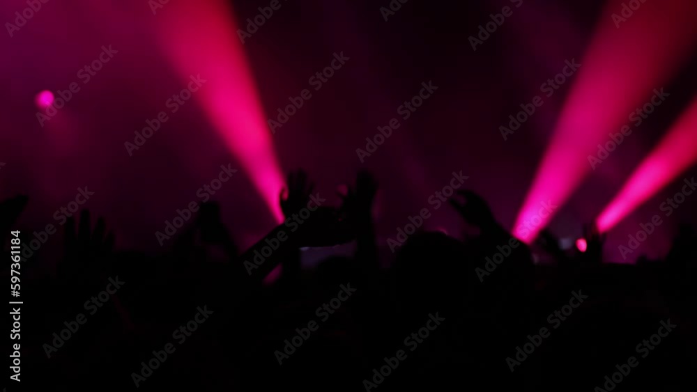 Red Lights and Modern Rhythms: DJ Performs High-Energy Music in Front of Fans on a Dynamic Stage Setting Red Lights and Modern Rhythms: DJ Performs High-Energy Music in Front of Fans on a Dynamic Stage Setting