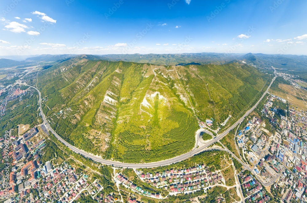 Gelendzhik, Russia. Mountain range. Text on the mountain with the name of the city of Gelendzhik. Worship cross. Summer. Aerial view
